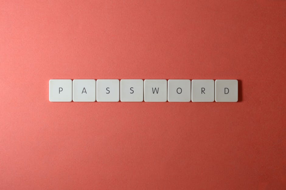 Focus on password security with white keyboard tiles spelling 'PASSWORD' on a coral background. — Photo by Miguel Á. Padriñán on Pexels